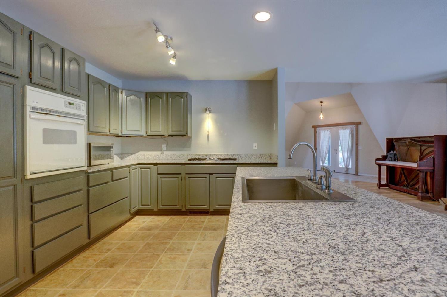 18125 Douglas Road Nevada City, CA 95959 - Photo 8 of 48 a kitchen with a refrigerator sink and stove