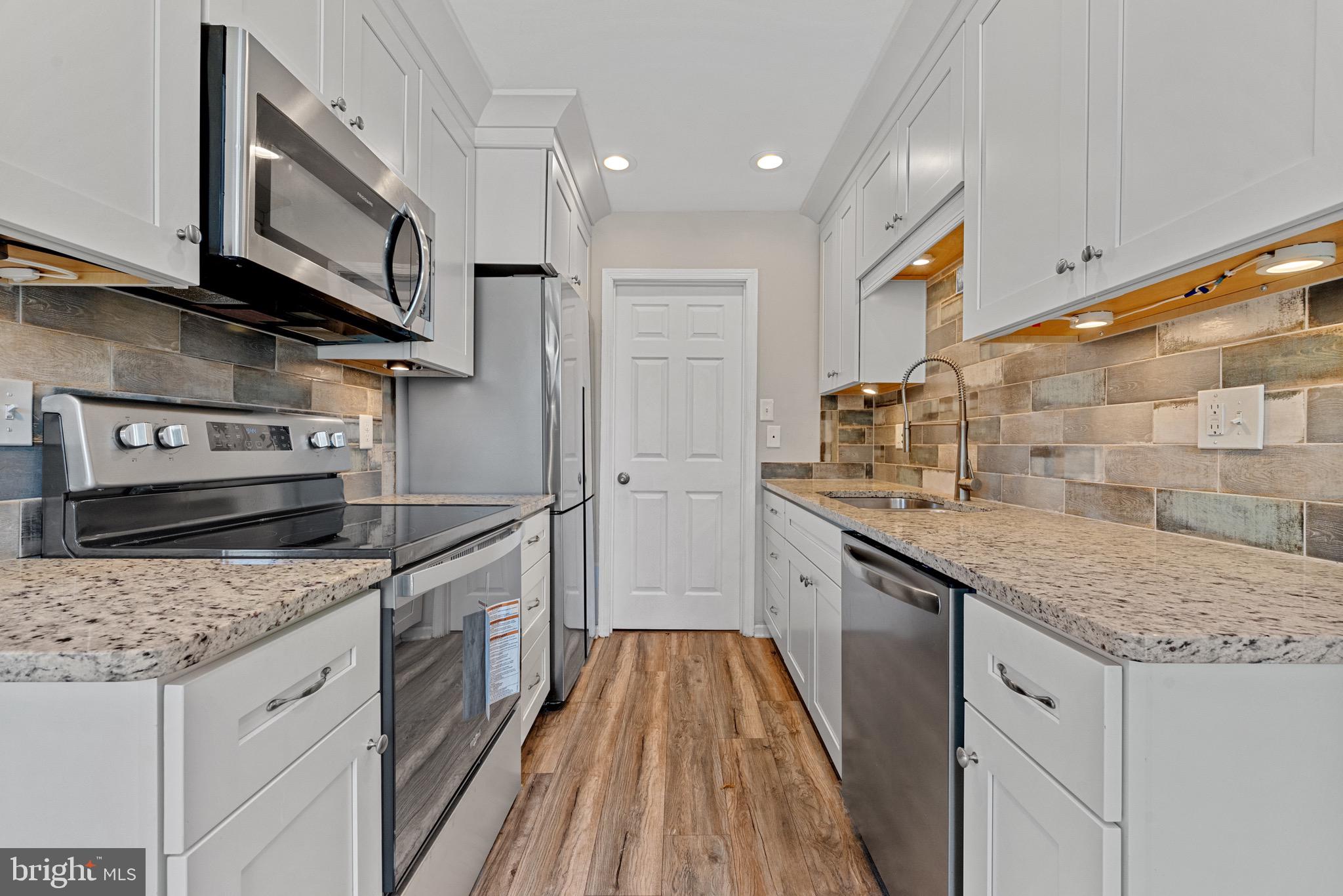 3403 Shell Road Hampton, VA 23661 - Photo 3 of 12 a kitchen with stainless steel appliances granite countertop a sink and stove