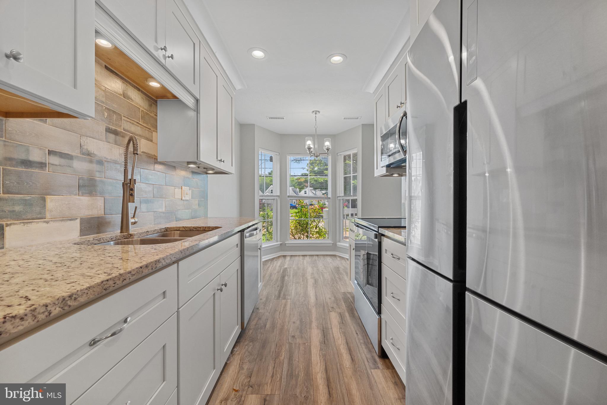 3403 Shell Road Hampton, VA 23661 - Photo 4 of 12 a kitchen with granite countertop a refrigerator and a sink