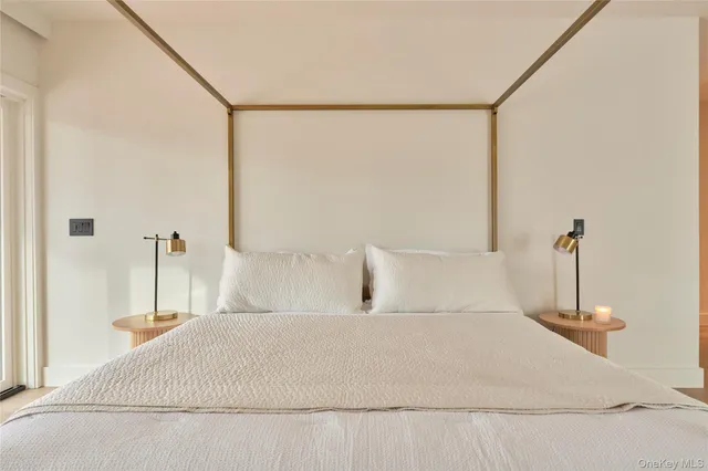 a bedroom with a bed and a night stand