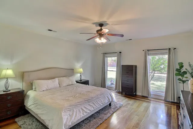 a bedroom with a bed and a chandelier