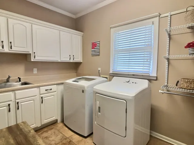 a utility room with closet dryer and washer