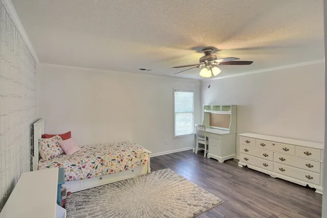 a bedroom with furniture and wooden floor