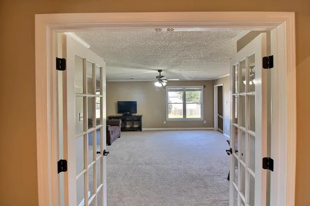 a view of livingroom with hardwood floor and a ceiling fan