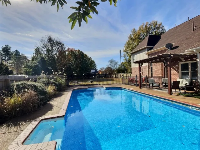a view of a swimming pool with lounge chair