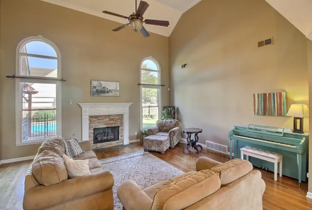 a living room with furniture fireplace and a window