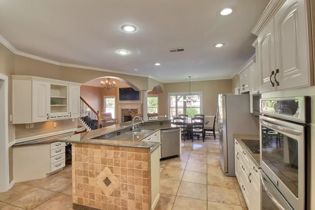 a kitchen with sink refrigerator and stove