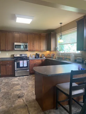 a large kitchen with lots of counter space cabinets and appliances
