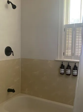 a bedroom with a bed next to a window