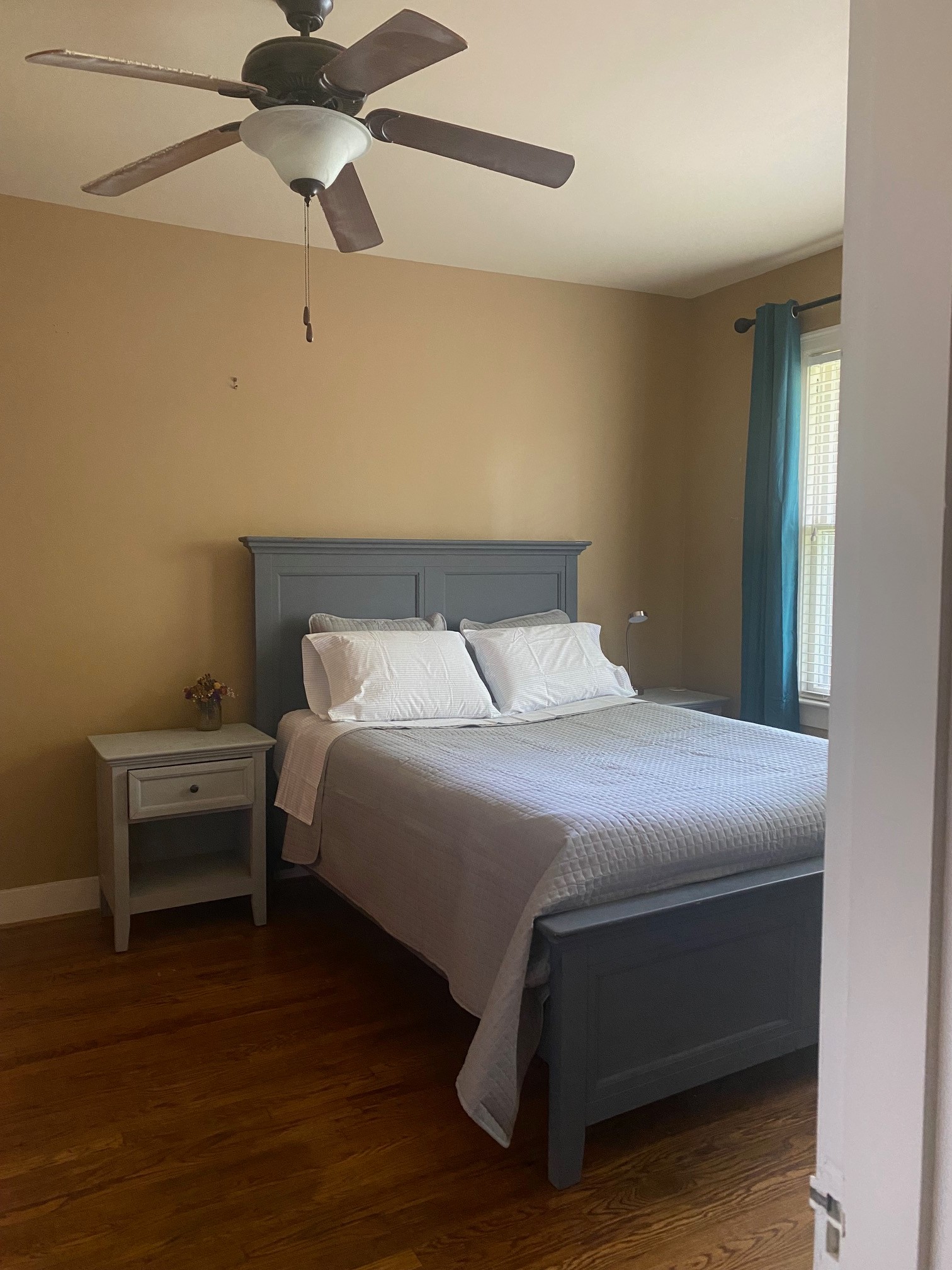 311 Main Street Martin, TN 38237 - Photo 29 of 49 a bedroom with a bed and a chandelier