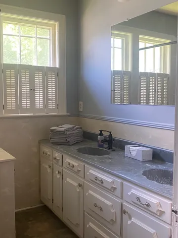 a spacious bedroom with a bed and window