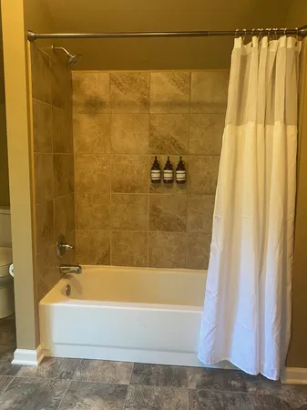 a bedroom with a bed and a ceiling fan
