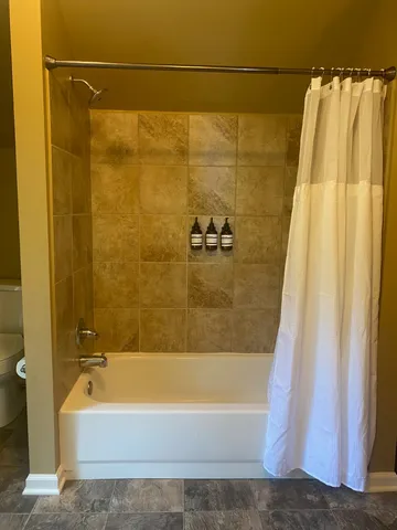 a bathroom with a toilet and a shower