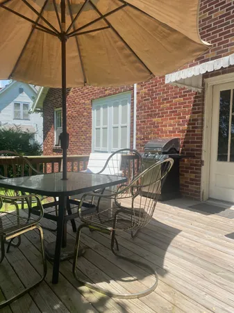 a patio with glass top table and chairs