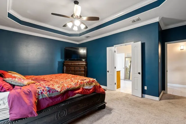 a bedroom with a bed and a chandelier