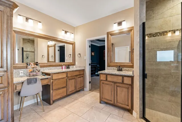 a large bathroom with a double vanity sink and a mirror