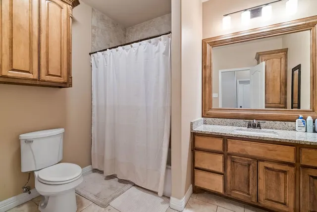 a bathroom with a toilet a sink and a mirror