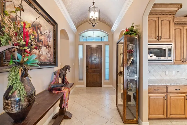 a view of a entryway with furniture and chandelier