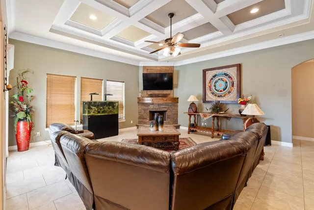 a living room with fireplace furniture and a flat screen tv