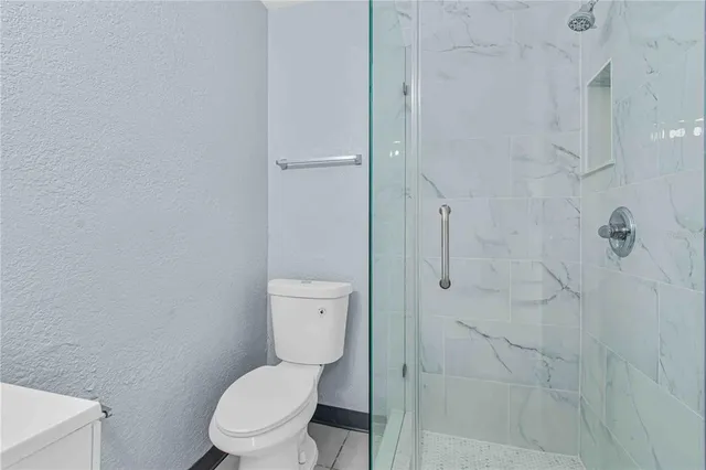 a white toilet sitting next to a bathroom sink