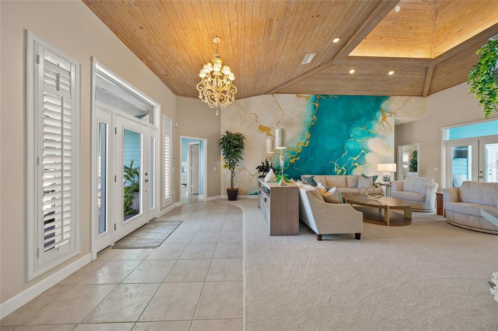 746 Eagle Point Drive Venice, FL 34285 - Photo 11 of 50 a living room with furniture a chandelier and a chandelier