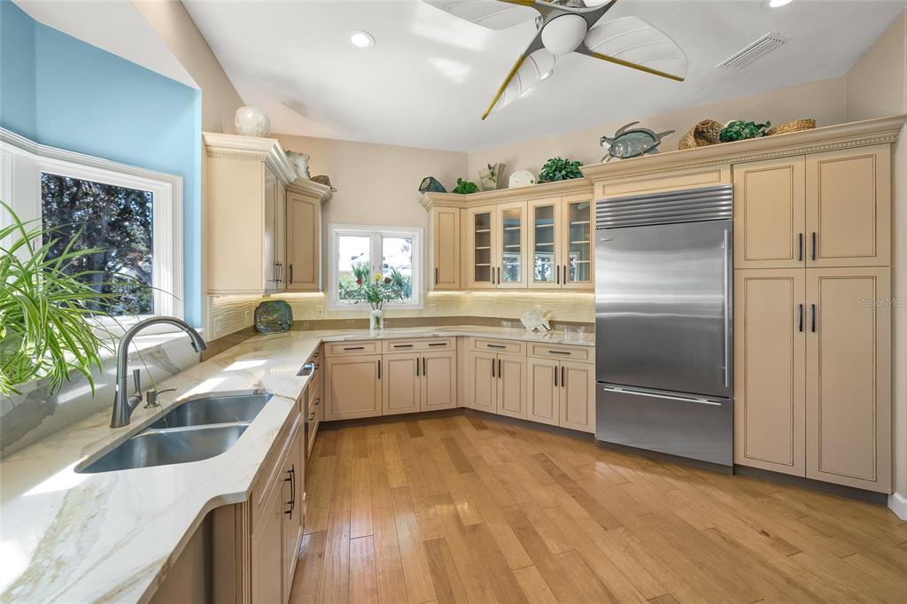 746 Eagle Point Drive Venice, FL 34285 - Photo 15 of 50 a kitchen with granite countertop a sink stainless steel appliances and counter space