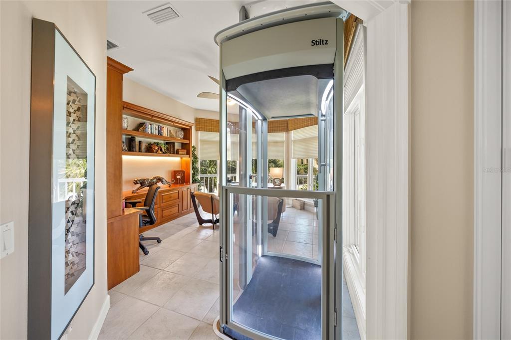 746 Eagle Point Drive Venice, FL 34285 - Photo 22 of 50 a view of a hallway with dining room and glass door