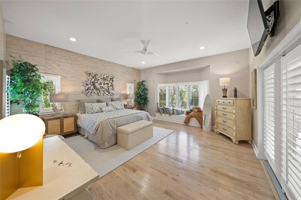 746 Eagle Point Drive Venice, FL 34285 - Photo 8 of 50 a spacious bedroom with a large bed and a couch