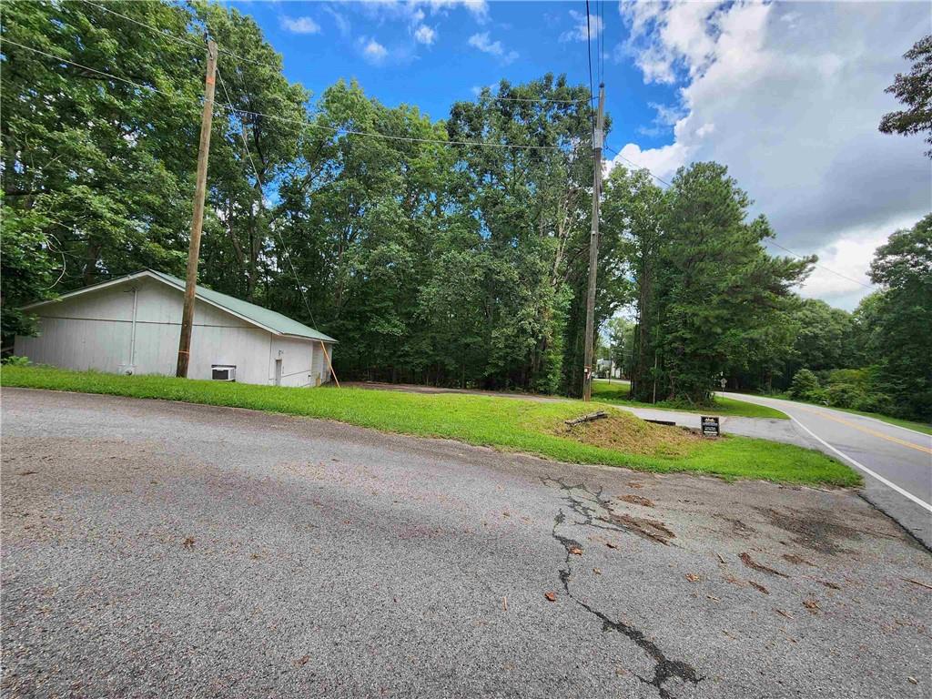 1397 McPherson Church Road Dallas, GA 30132 - Photo 7 of 9 a view of a house with a yard and large trees
