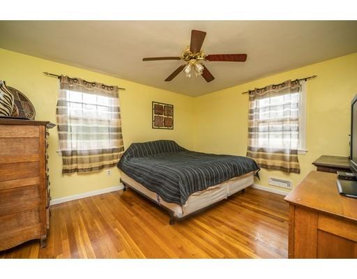 86 Hadley Street Springfield, MA 01118 - Photo 14 of 29 a bedroom with a bed and wooden floor