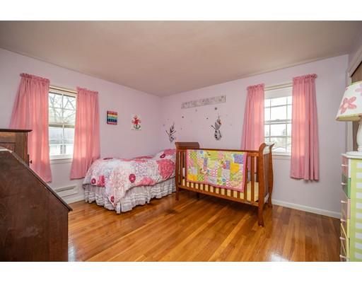 86 Hadley Street Springfield, MA 01118 - Photo 16 of 29 a bedroom with a bed and wooden floor