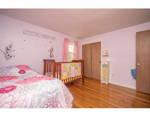 86 Hadley Street Springfield, MA 01118 - Photo 17 of 29 a bedroom with a bed and wooden floor
