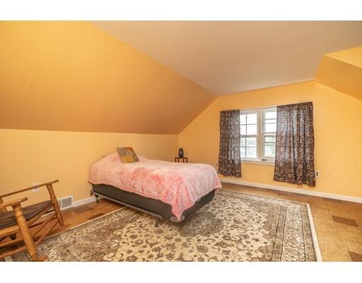86 Hadley Street Springfield, MA 01118 - Photo 18 of 29 a spacious bedroom with a bed and wooden floor