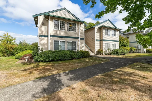 a front view of a house with a garden
