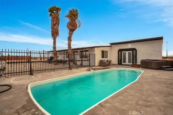 a view of a backyard with a swimming pool