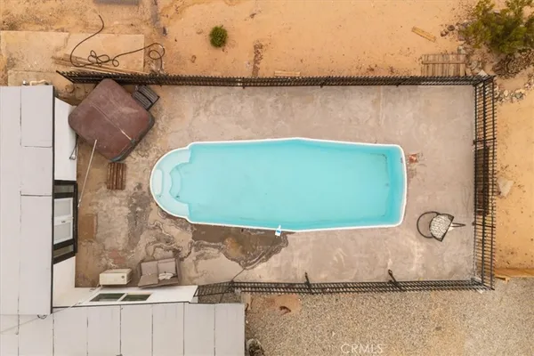 a swimming pool with outdoor seating and yard