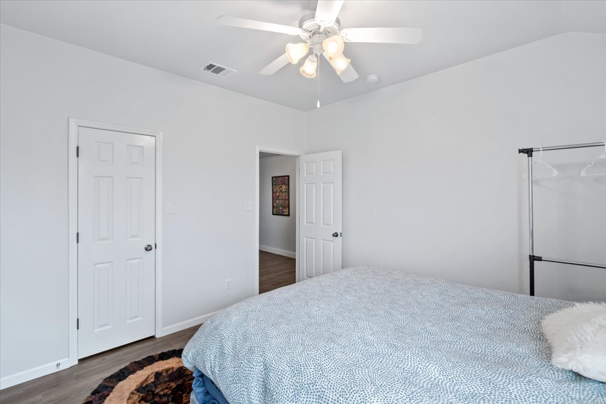 2338 Brookhollow Terrace Georgetown, TX 78626 - Photo 13 of 37 a bedroom with a bed and a chandelier