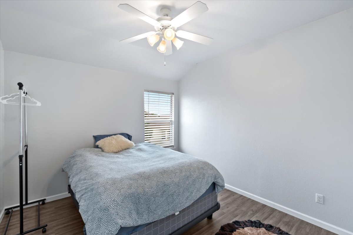 2338 Brookhollow Terrace Georgetown, TX 78626 - Photo 14 of 37 a bedroom with a bed and a chandelier
