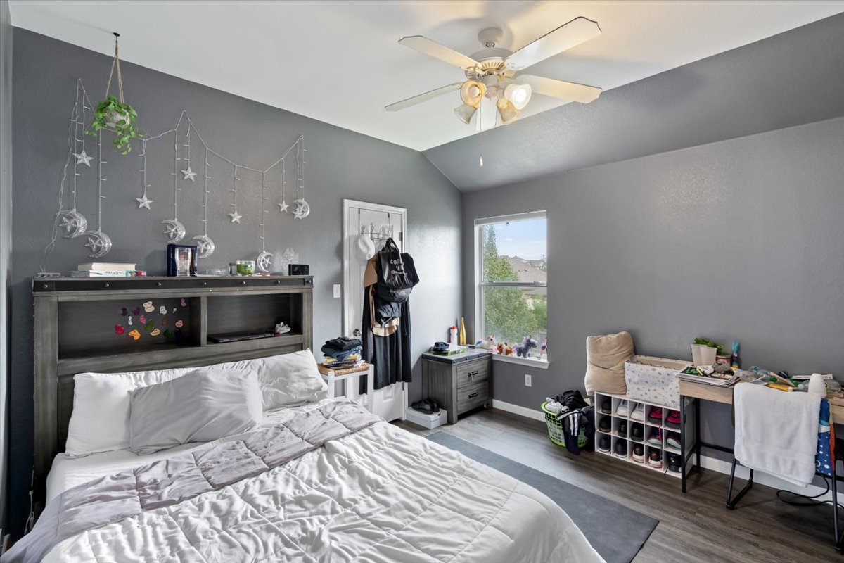 2338 Brookhollow Terrace Georgetown, TX 78626 - Photo 15 of 37 a bedroom with a bed and a chandelier