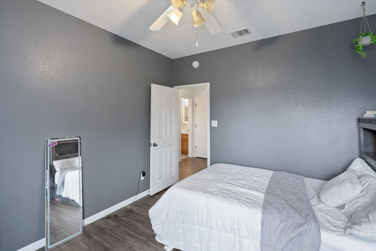2338 Brookhollow Terrace Georgetown, TX 78626 - Photo 16 of 37 a bedroom with a bed and a chandelier