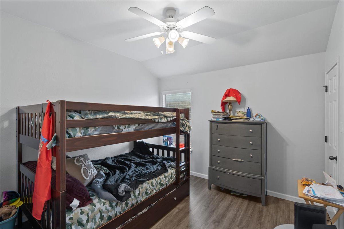 2338 Brookhollow Terrace Georgetown, TX 78626 - Photo 17 of 37 a bedroom with a bed and a chandelier