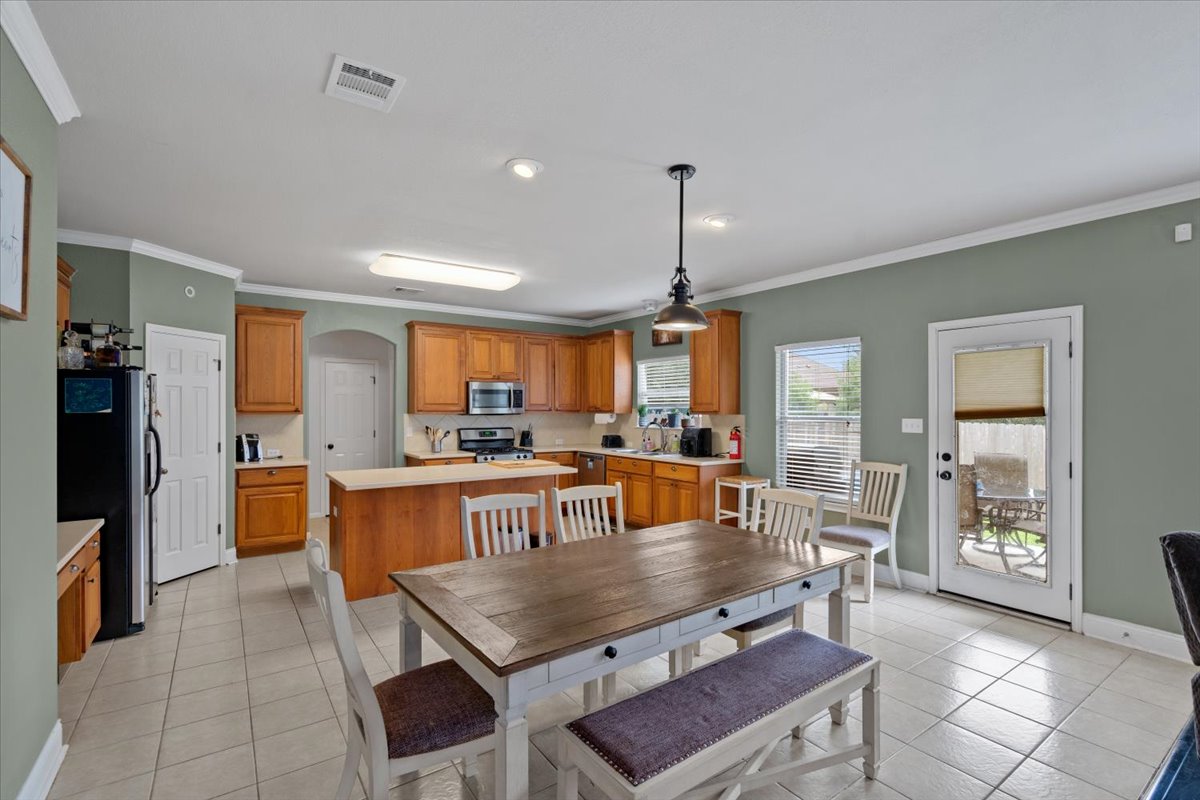 2338 Brookhollow Terrace Georgetown, TX 78626 - Photo 26 of 37 a dining hall with stainless steel appliances granite countertop a stove and a dining table chair
