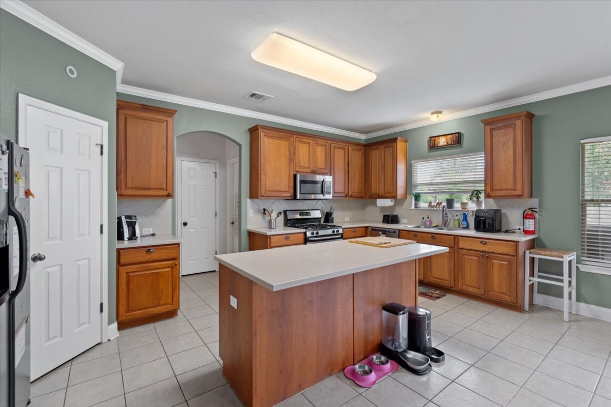 2338 Brookhollow Terrace Georgetown, TX 78626 - Photo 27 of 37 a kitchen with stainless steel appliances granite countertop a stove top oven a sink dishwasher and a refrigerator