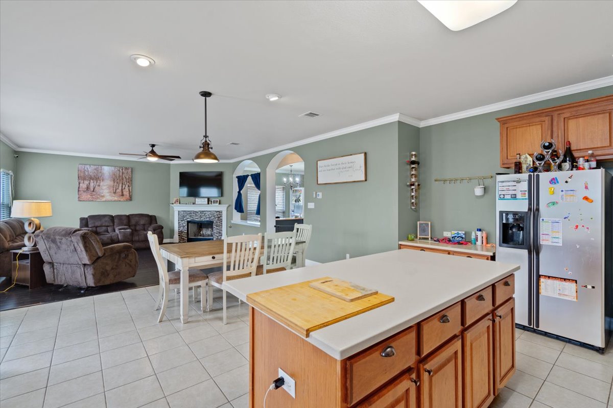 2338 Brookhollow Terrace Georgetown, TX 78626 - Photo 28 of 37 a kitchen with stainless steel appliances kitchen island granite countertop a table chairs and a refrigerator