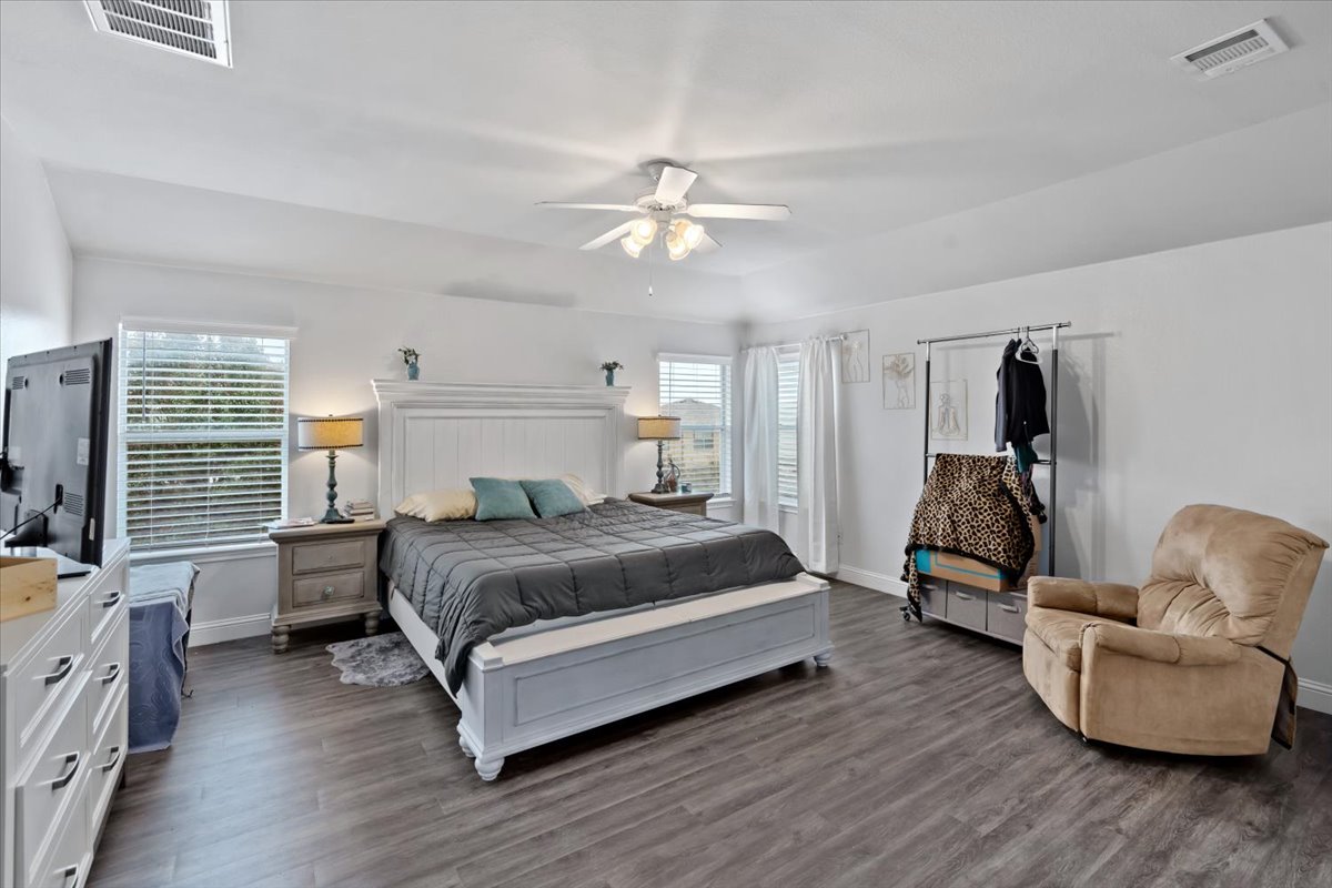 2338 Brookhollow Terrace Georgetown, TX 78626 - Photo 6 of 37 a bedroom with a bed and furniture with wooden floor