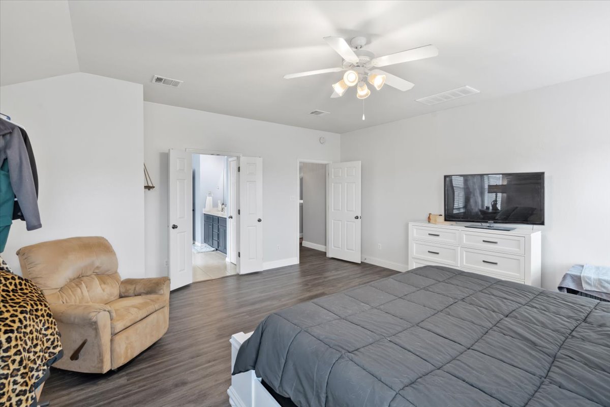 2338 Brookhollow Terrace Georgetown, TX 78626 - Photo 7 of 37 a spacious bedroom with a bed and flat screen tv