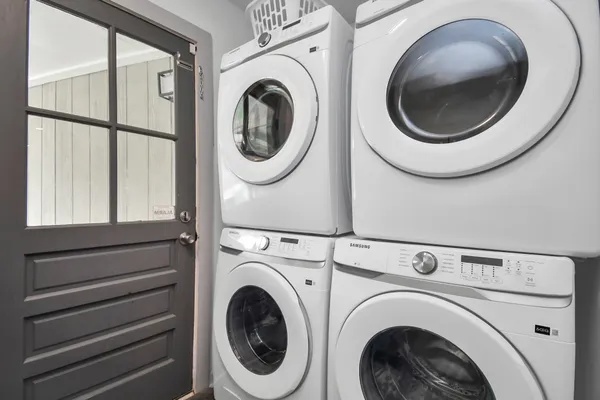 a view of a hallway with washer and dryer