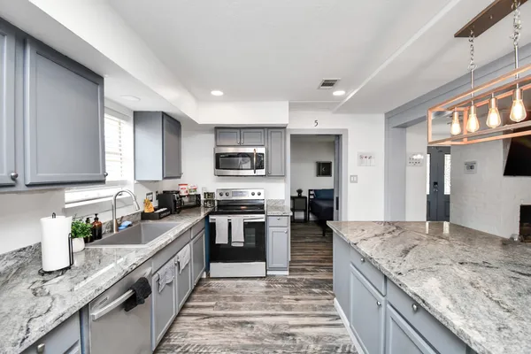 a large kitchen with granite countertop lots of counter top space