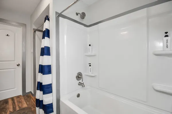 a bathroom with a bathtub and a shower
