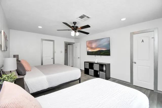 a bedroom with a bed and a flat screen tv